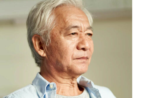 Cover of the patient charter showing a man of Asian descent looking away from the camera