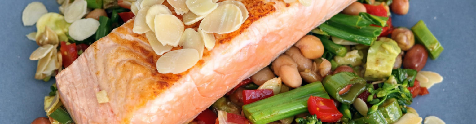 Pan-fried salmon served on a bean and broccolini salad with capsicum, avocado and flaked almonds.